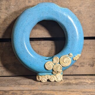 Donut Vase glazed in matte turquoise, embellished with unglazed clay.